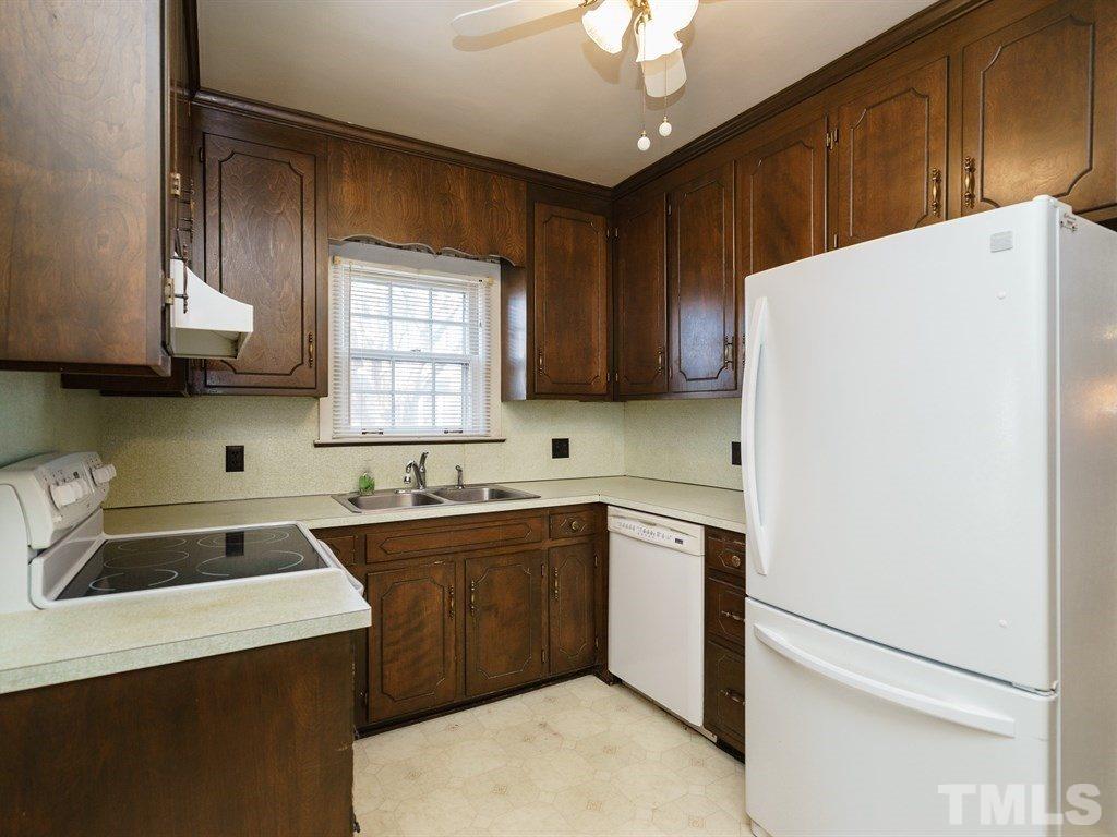 713 Kimbrough Street Raleigh, NC 27608 - Photo 8 of 25 a kitchen with a sink a stove and refrigerator