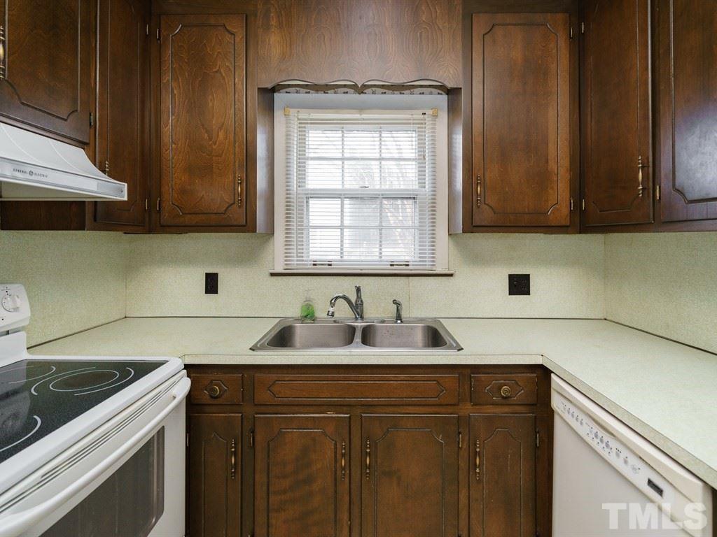 713 Kimbrough Street Raleigh, NC 27608 - Photo 9 of 25 a kitchen with granite countertop a sink stainless steel appliances and cabinets