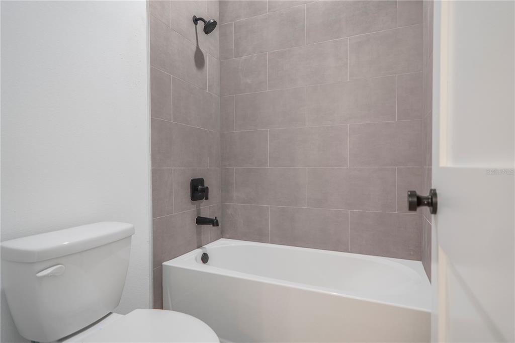 1915 West Linden Drive Dunnellon, FL 34434 - Photo 29 of 51 a white bath tub sitting next to a white toilet