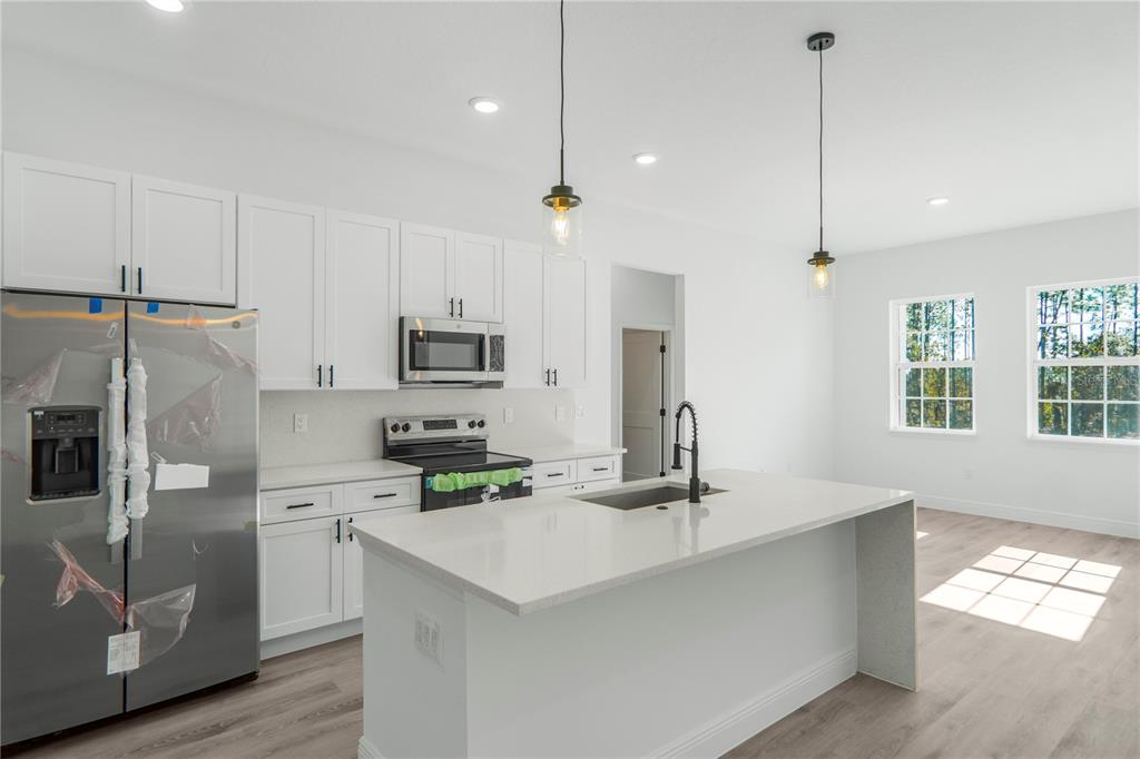 1915 West Linden Drive Dunnellon, FL 34434 - Photo 41 of 51 a kitchen with stainless steel appliances a refrigerator sink and microwave