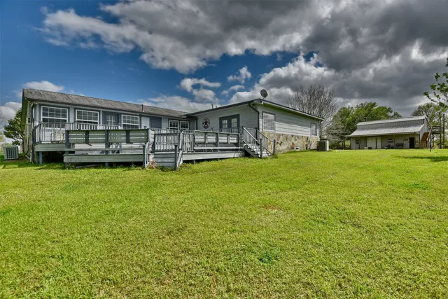 a kitchen with stainless steel appliances granite countertop a refrigerator a oven a sink with island and chairs