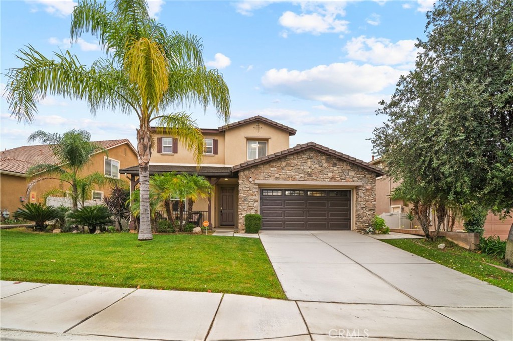11345 Sanders Street Beaumont, CA 92223 - Photo 1 of 56 a front view of a house with a garden and trees