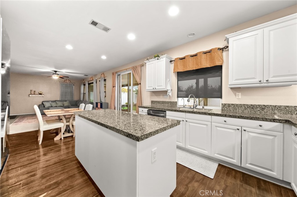 11345 Sanders Street Beaumont, CA 92223 - Photo 16 of 56 a kitchen with granite countertop a sink and cabinets