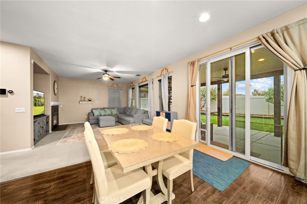 11345 Sanders Street Beaumont, CA 92223 - Photo 17 of 56 a view of a dining room with furniture window and wooden floor