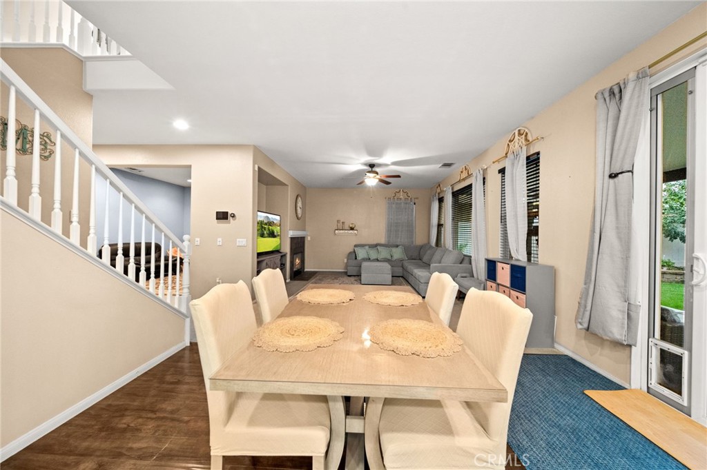 11345 Sanders Street Beaumont, CA 92223 - Photo 18 of 56 a view of a dining room with furniture and wooden floor