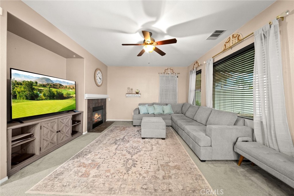 11345 Sanders Street Beaumont, CA 92223 - Photo 20 of 56 a living room with furniture and a flat screen tv