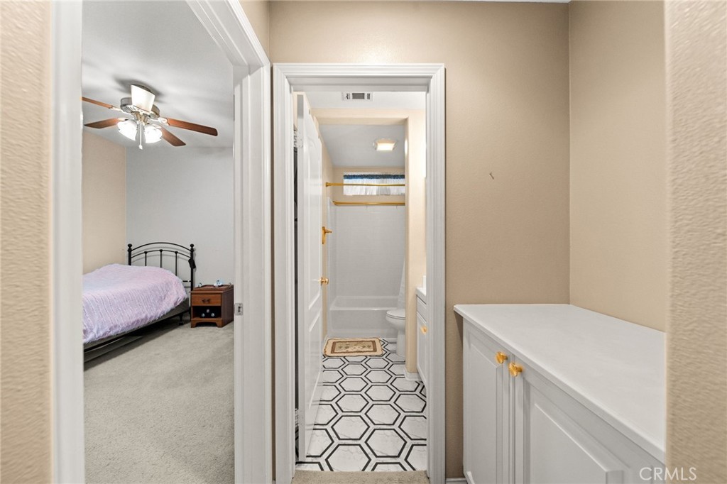 11345 Sanders Street Beaumont, CA 92223 - Photo 23 of 56 a bathroom with a granite countertop sink a toilet and shower
