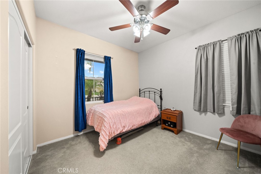 11345 Sanders Street Beaumont, CA 92223 - Photo 25 of 56 a bedroom with a bed and a chandelier
