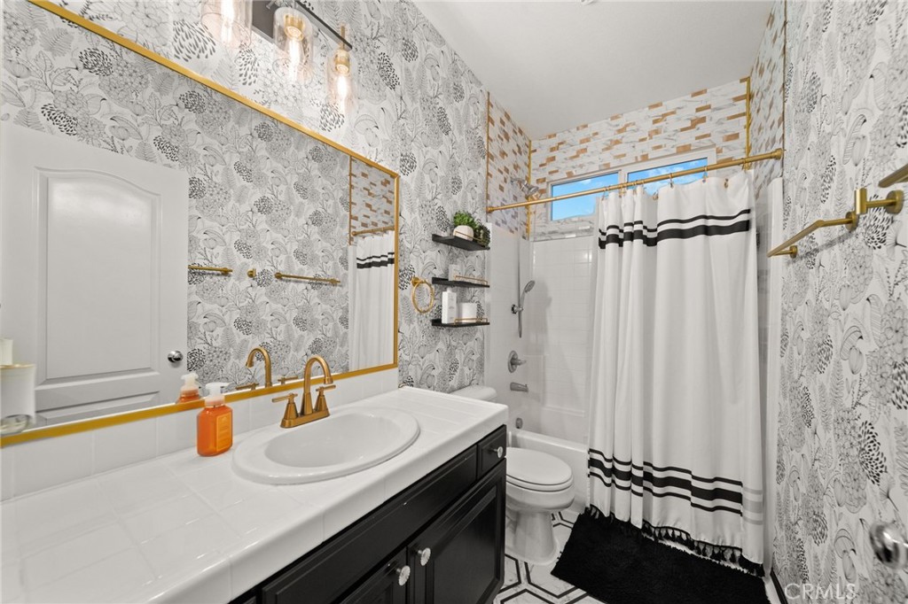 11345 Sanders Street Beaumont, CA 92223 - Photo 29 of 56 a bathroom with a sink and a mirror