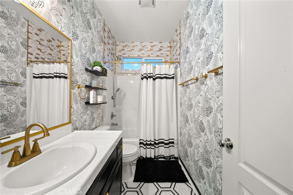 11345 Sanders Street Beaumont, CA 92223 - Photo 30 of 56 a bathroom with a sink toilet and shower