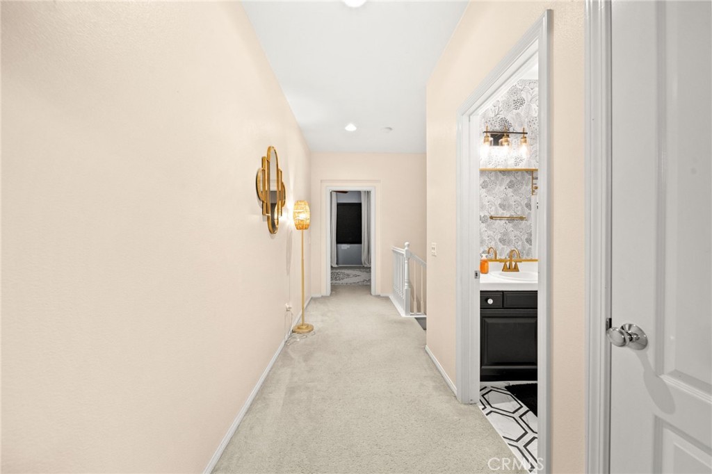 11345 Sanders Street Beaumont, CA 92223 - Photo 35 of 56 a view of a hallway with wooden cabinets and entryway