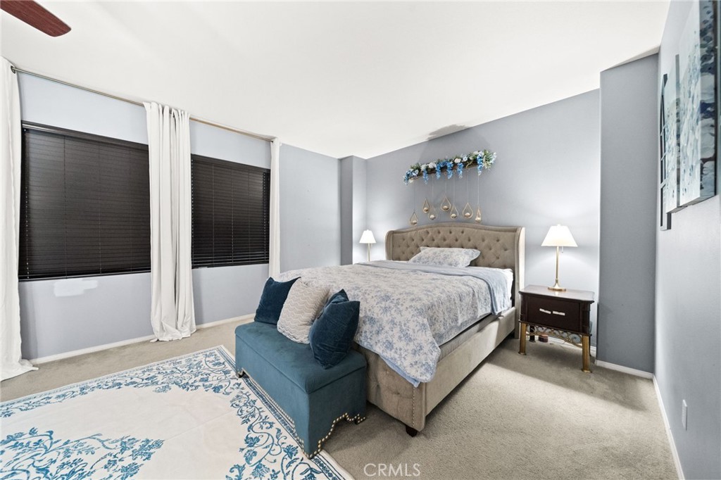 11345 Sanders Street Beaumont, CA 92223 - Photo 37 of 56 a bedroom with a bed and a mirror