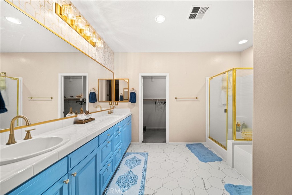 11345 Sanders Street Beaumont, CA 92223 - Photo 41 of 56 a spacious bathroom with a double vanity sink and a mirror