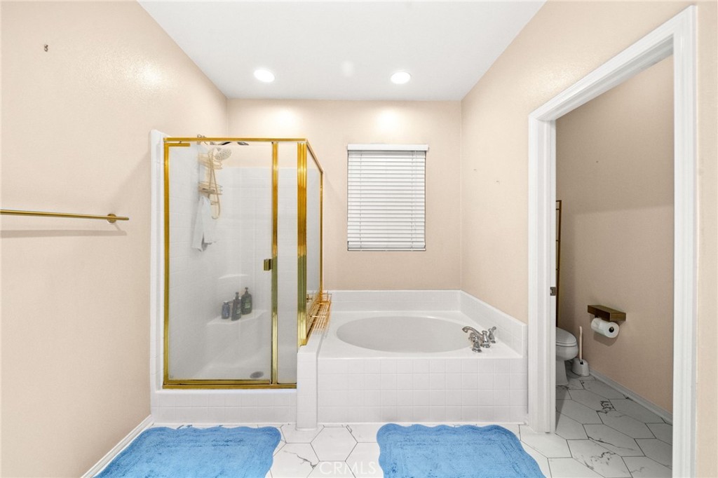 11345 Sanders Street Beaumont, CA 92223 - Photo 42 of 56 a bathroom with a bathtub and a shower