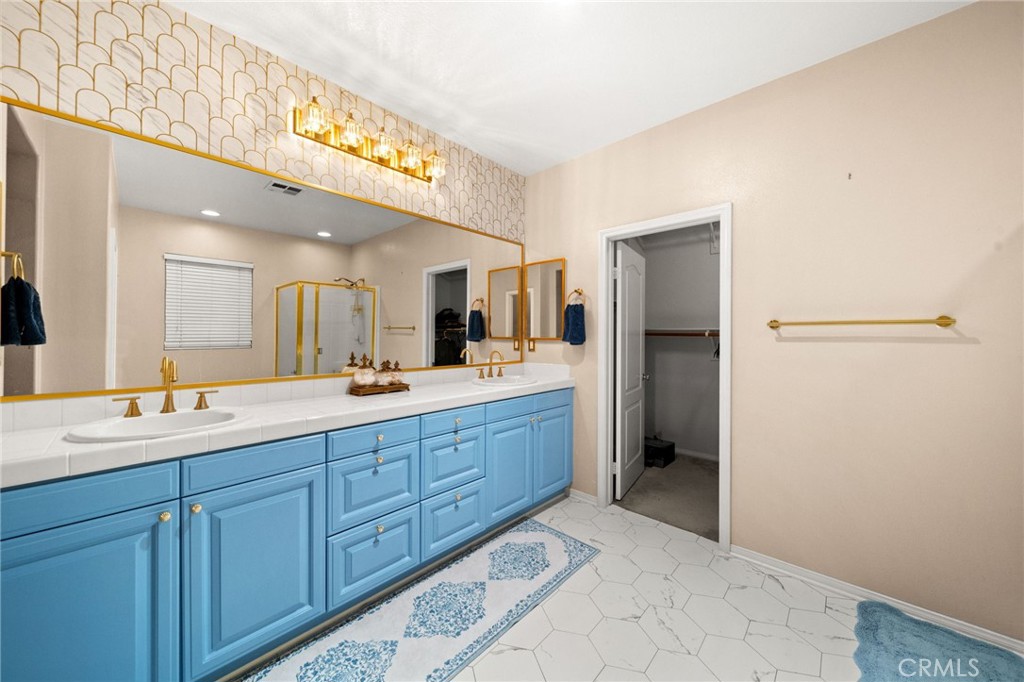 11345 Sanders Street Beaumont, CA 92223 - Photo 44 of 56 a spacious bathroom with a double vanity sink and a mirror