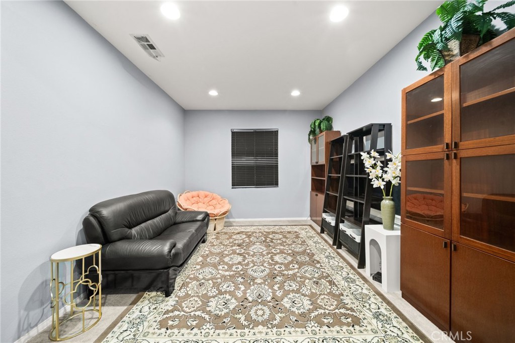 11345 Sanders Street Beaumont, CA 92223 - Photo 7 of 56 a hallway with a couch and a potted plant