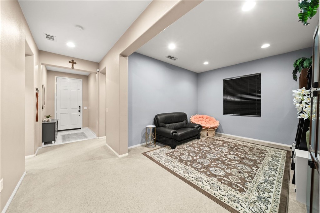 11345 Sanders Street Beaumont, CA 92223 - Photo 8 of 56 a bedroom with a bed and a couch