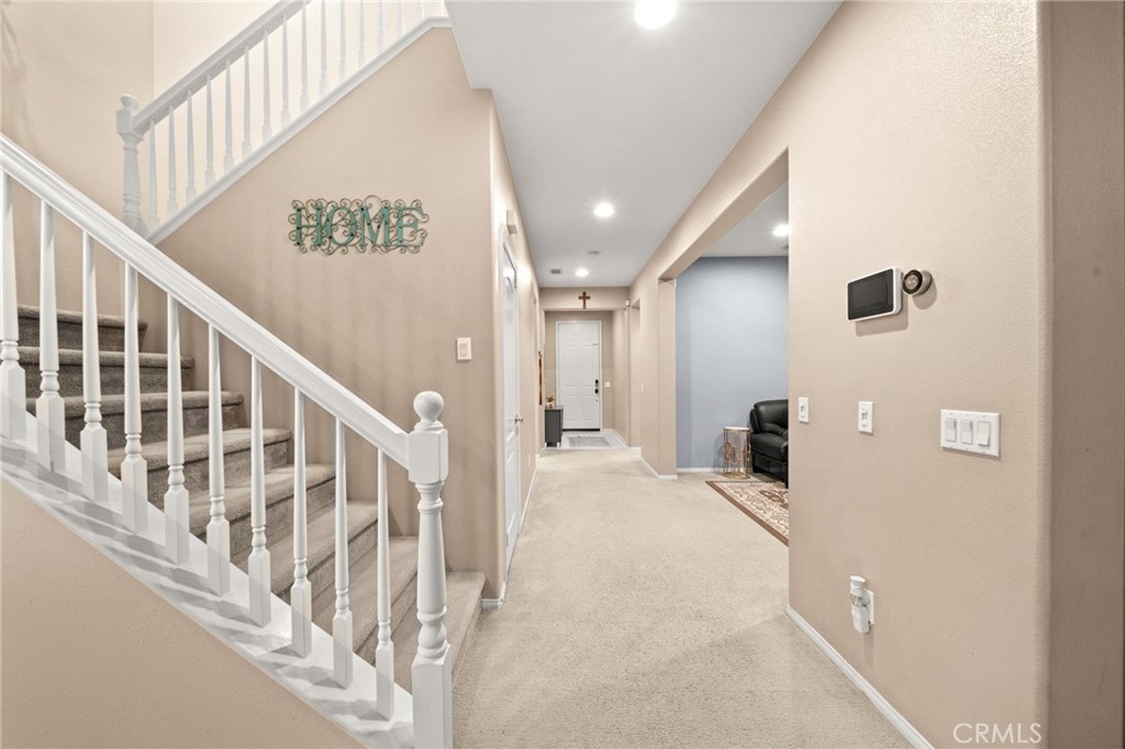 11345 Sanders Street Beaumont, CA 92223 - Photo 9 of 56 a view of staircase with white walls and a next to a window