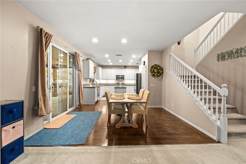 11345 Sanders Street Beaumont, CA 92223 - Photo 10 of 56 a dining room with furniture wooden floor and a rug