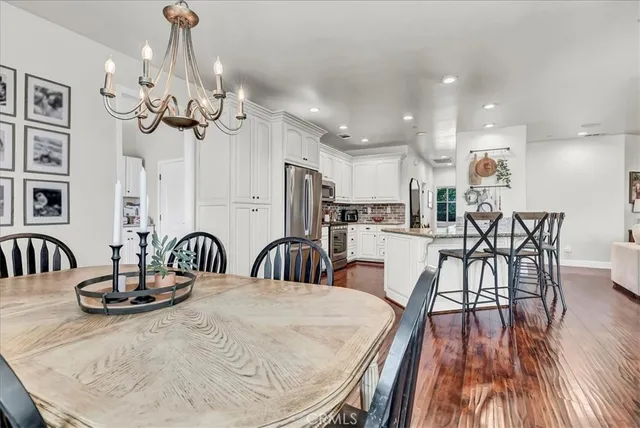 a kitchen with granite countertop white cabinets white stainless steel appliances and sink