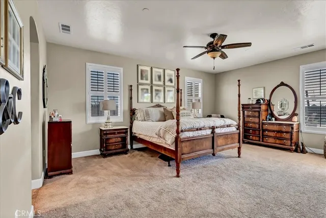 a bedroom with a bed furniture and windows