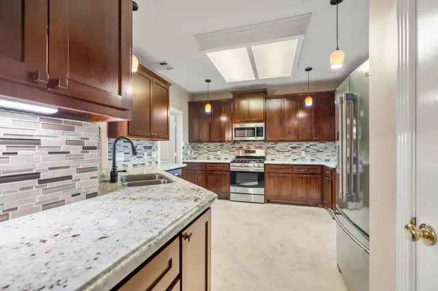 a kitchen with a stove a refrigerator and cabinets