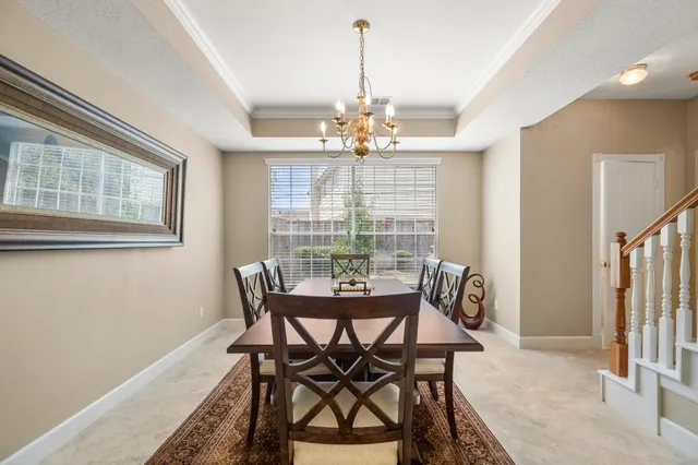 a view of a dining room with furniture wooden floor and chandelier