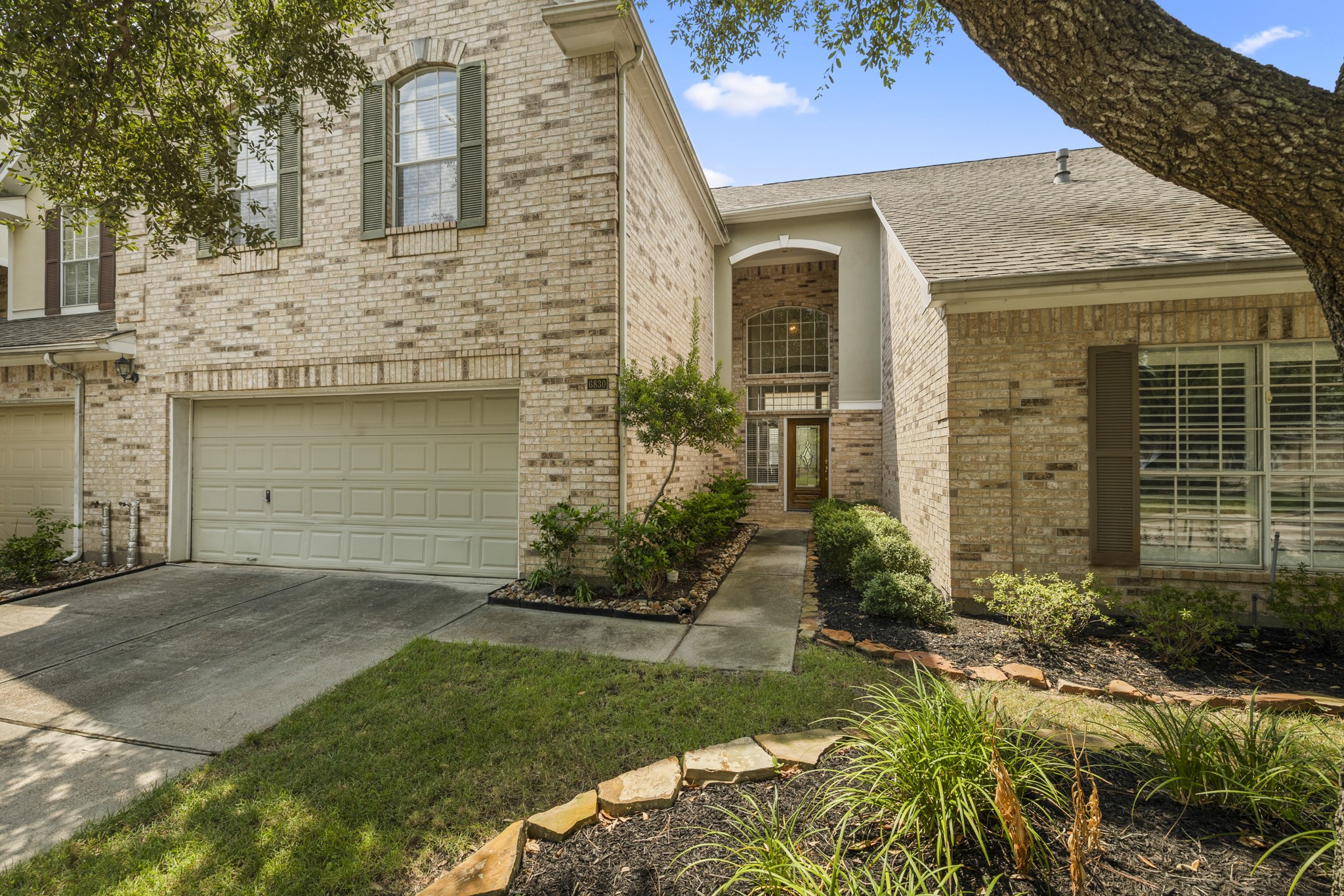 6830 Jasmine Place Spring, TX 77379 - Photo 2 of 38 a front view of a house with a garden and plants