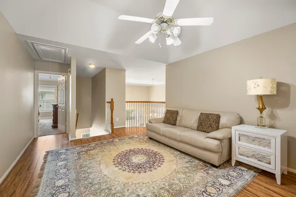 a living room with furniture and a chandelier