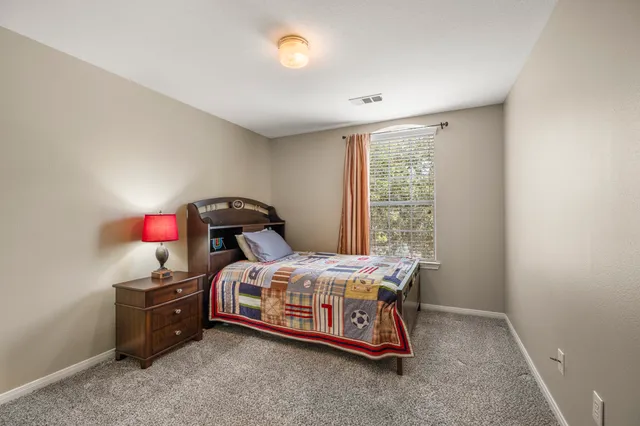 a bedroom with a bed and a window