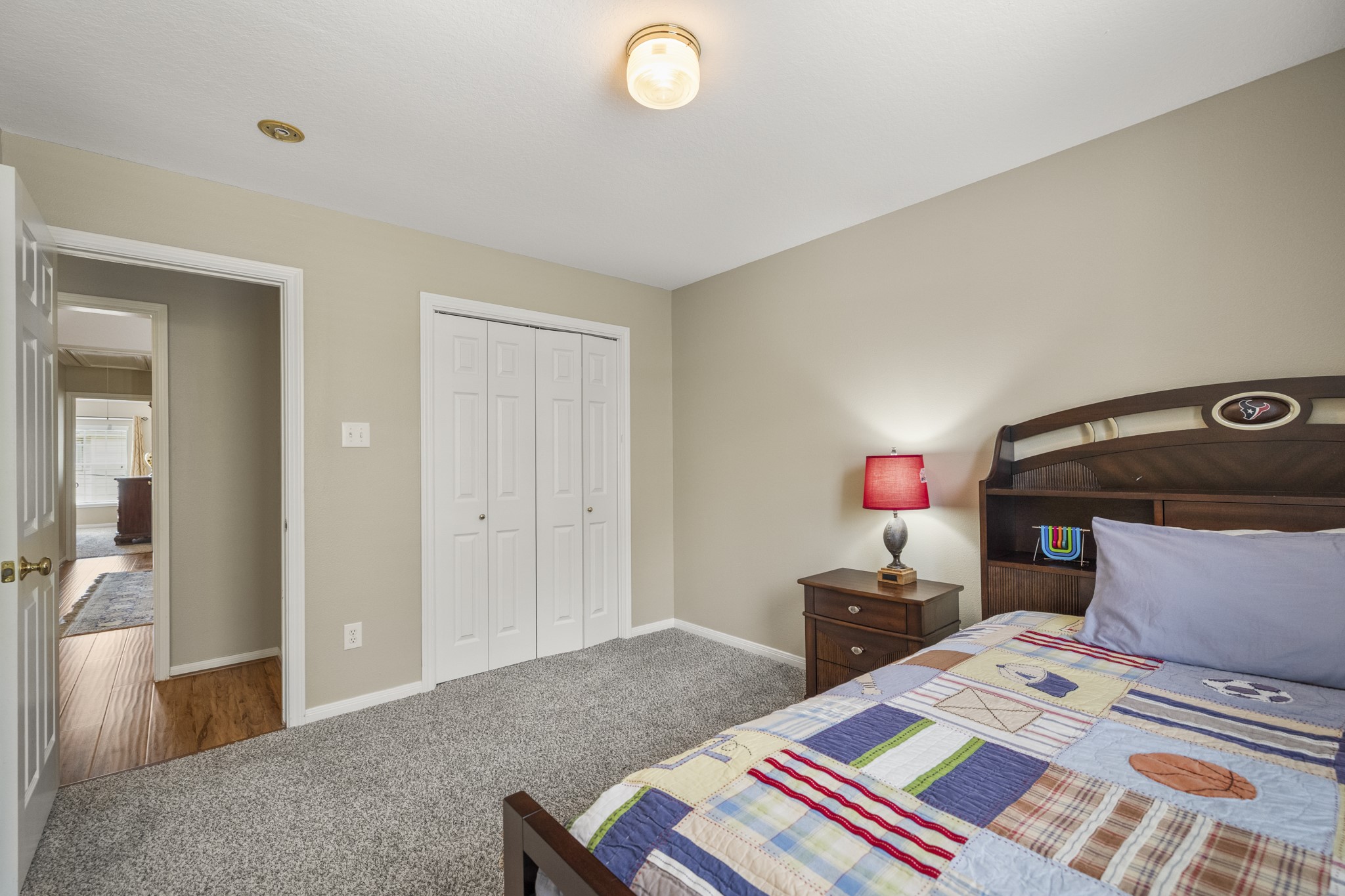 6830 Jasmine Place Spring, TX 77379 - Photo 28 of 38 a bedroom with a bed and a chandelier