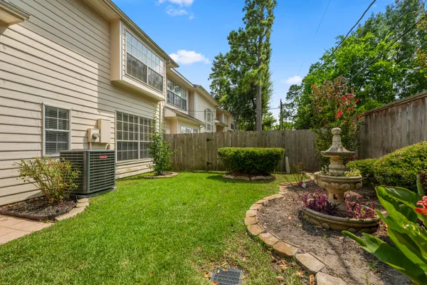 a view of a backyard with plants and a garden
