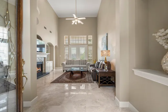 a living room with furniture and a chandelier