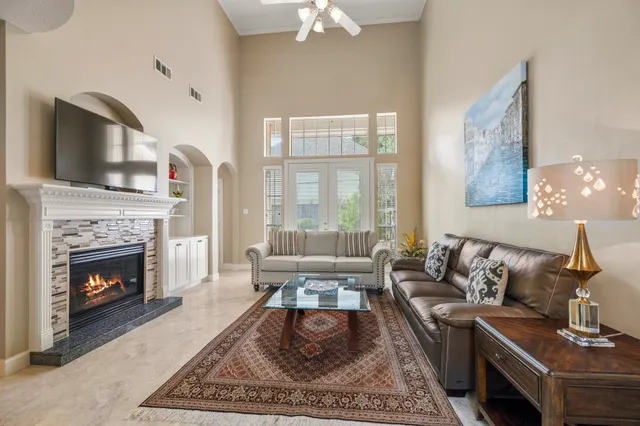 a living room with furniture and a fireplace