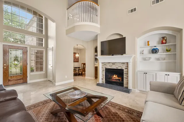 a living room with furniture fireplace and flat screen tv