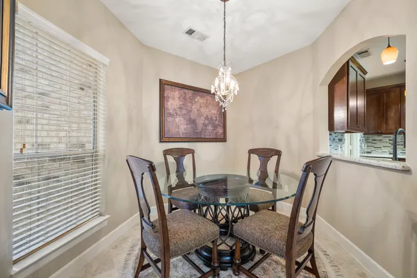 a view of a dining room with furniture and chandelier