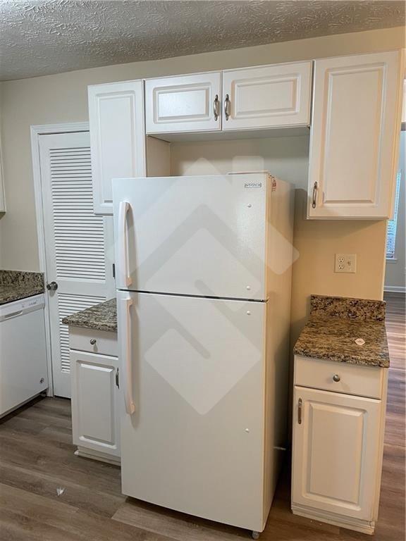 4267 Grogan Street Acworth, GA 30101 - Photo 12 of 37 a kitchen with white cabinets and white appliances