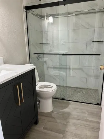 a bathroom with a toilet a sink and a shower