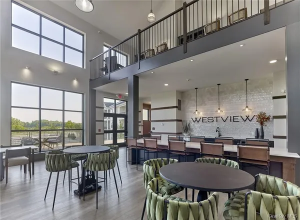 a living room with furniture and a floor to ceiling window