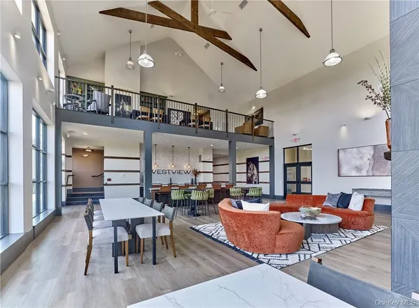 a dining room with stainless steel appliances kitchen island a table and chairs