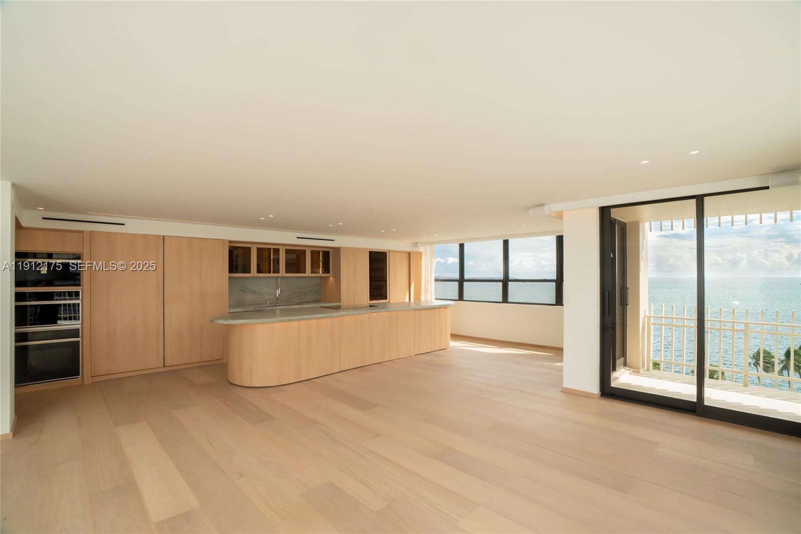 3 Grove Isle Drive, Unit C902 Miami, FL 33133 - Photo 2 of 7 an empty room with sliding door and windows