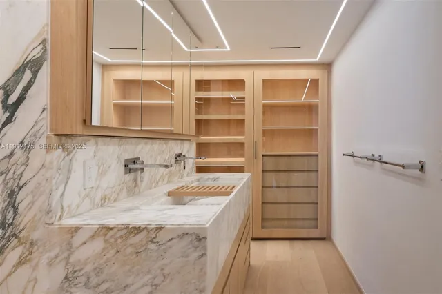a bathroom with a granite countertop sink a vanity and shower