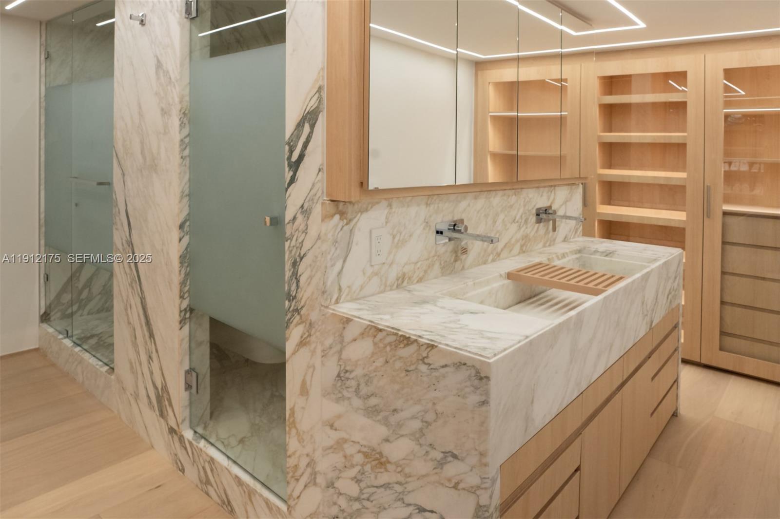 3 Grove Isle Drive, Unit C902 Miami, FL 33133 - Photo 6 of 7 a bathroom with a sink and a mirror