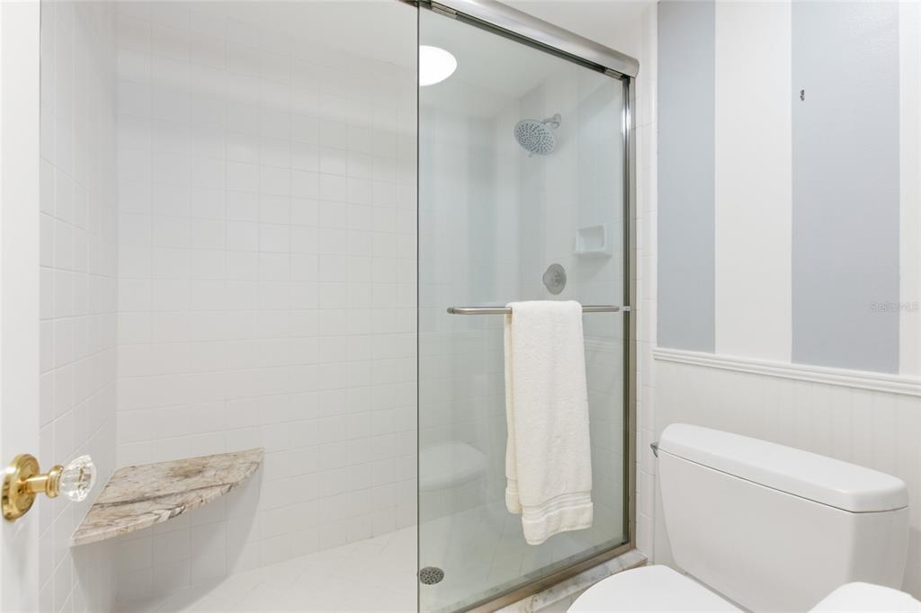 4420 Exeter Drive, Unit 303 Longboat Key, FL 34228 - Photo 13 of 42 a bathroom with a shower and a toilet