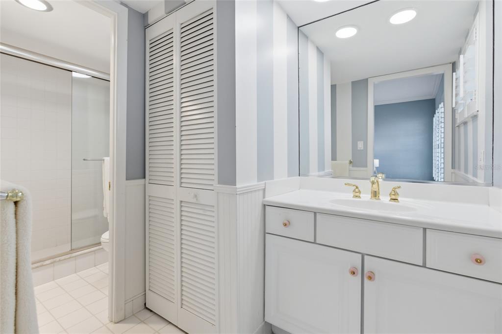 4420 Exeter Drive, Unit 303 Longboat Key, FL 34228 - Photo 14 of 42 a bathroom with a sink and a mirror