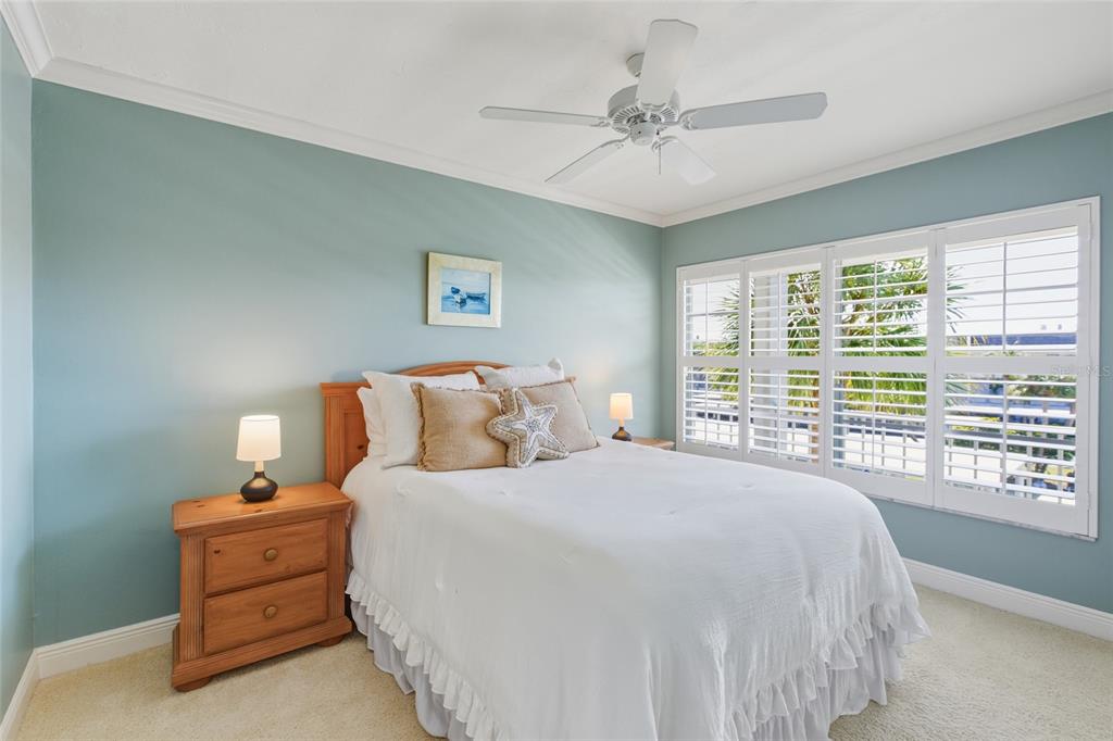 4420 Exeter Drive, Unit 303 Longboat Key, FL 34228 - Photo 21 of 42 a spacious bedroom with a bed and a large window