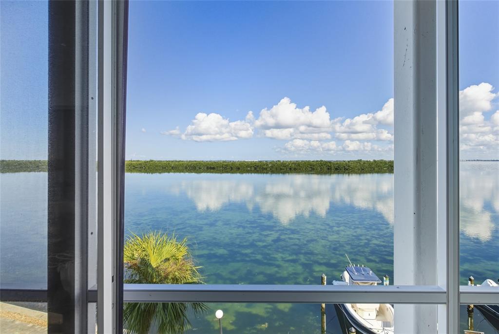 4420 Exeter Drive, Unit 303 Longboat Key, FL 34228 - Photo 24 of 42 a view of a lake from a window