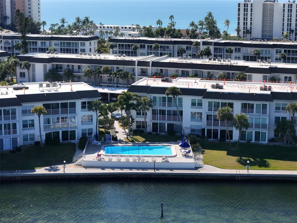 4420 Exeter Drive, Unit 303 Longboat Key, FL 34228 - Photo 27 of 42 a view of swimming pool with outdoor seating and yard