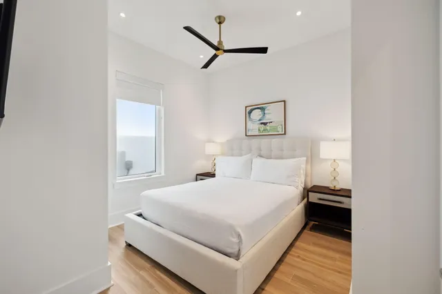 a bedroom with a bed and a ceiling fan