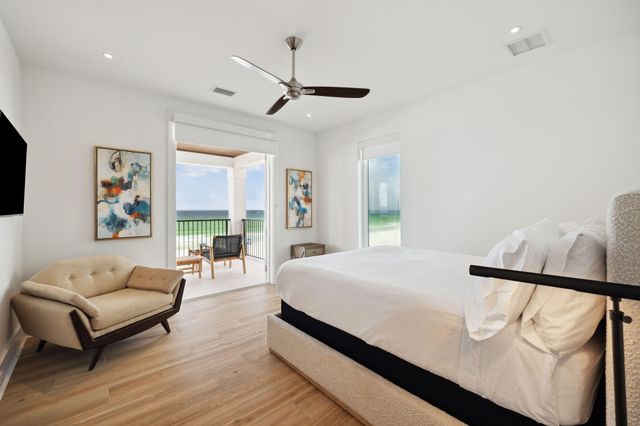 a bedroom with a bed couch and window